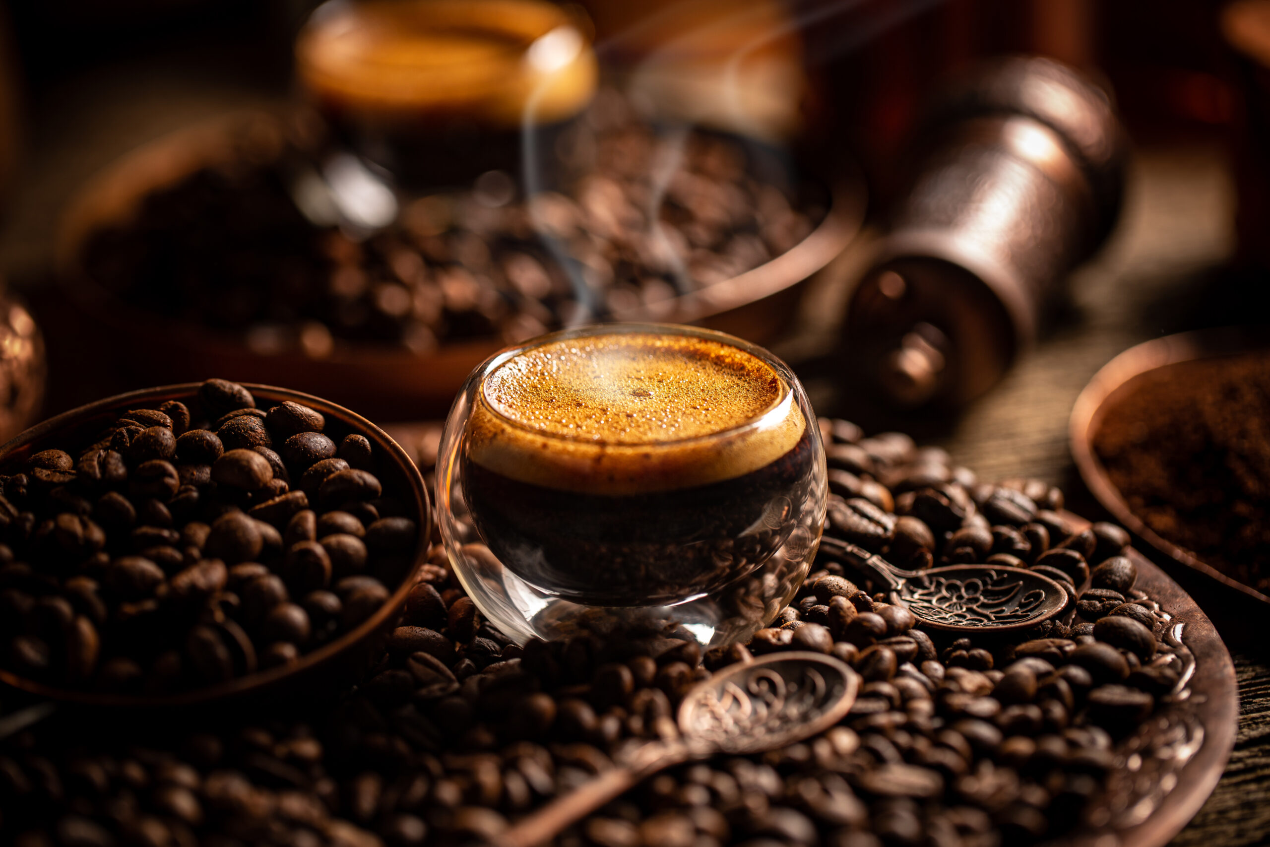 Coffee brewing concept. Espresso in glass cup and coffee beans